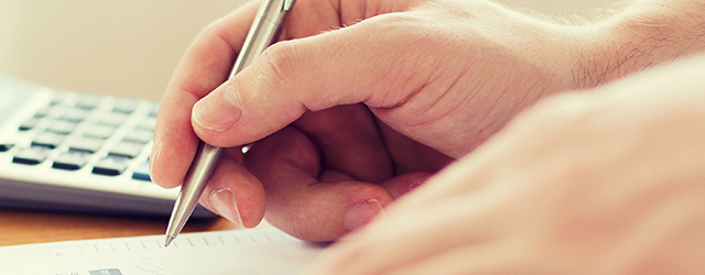 person writing at desk