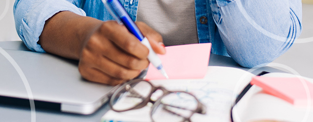 person writing at desk